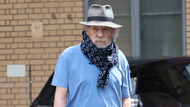 Ian McKellen hides neck brace with a scarf after falling off west end stage